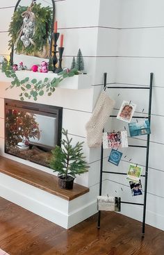 a living room filled with furniture and a fire place next to a christmas tree on top of a mantel