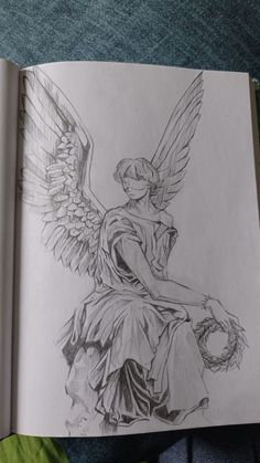 a drawing of an angel sitting on top of a book