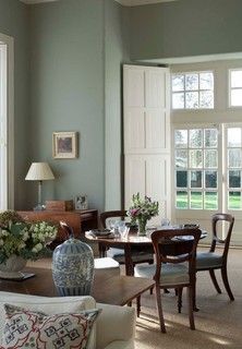 a living room filled with furniture and lots of windows