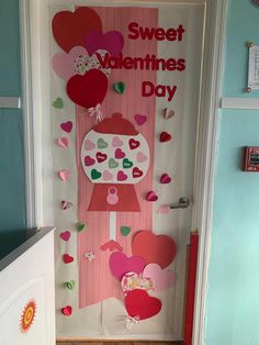 a door decorated with paper hearts and a sign that says sweet valentine's day