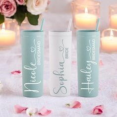 three personalized tumbles with candles and flowers in the background