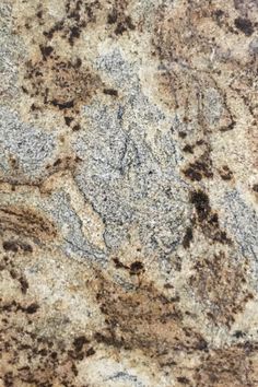 a granite counter top with brown and white colors