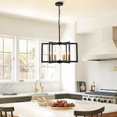 a kitchen with white counters and wooden chairs