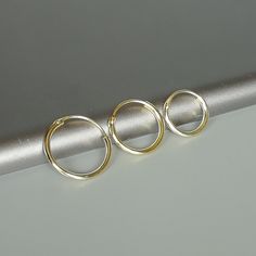 A SET of gold plated sterling silver hoops in three sizes 12,14,18 m. You get THREE hoops when u buy. Size: 1 x 12,14,18 mm These earrings are made of 925 hypoallergenic sterling silver with gold plating. They are nickel free. This piece is sent in a gift box. I can include a personal message from you if needed. You are welcome to contact me at... bhavnakwintra1956@gmail.com More hoops: https://www.etsy.com/your/shops/TheSilverGame/tools/listings/section:26305414 More earrings: https://www.etsy. Hoops Silver, Cartilage Hoop, Hoops Gold, Hoop Earring Sets, Skull Earrings, Beaded Hoops, Pearl Charms, Sterling Silver Hoops, Gold Hoops