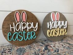 two wooden signs that say happy easter and have bunny ears on them