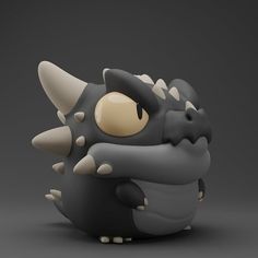 a black and white toy with horns on it's head, sitting in front of a gray background