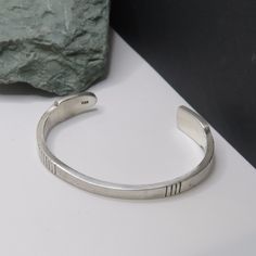 This sterling cuff measures 6 3/4 inches around the inside including the gap which measures 1 1/4 inches. It is 4.3 mm wide in the middle and 10.3 mm wide at one end. SIGNED sterling silver cuff bracelet, marked 925, vintage, 26.4 grams. The band has a slightly hammered or textured look. PLEASE CHECK THAT IT WILL FIT BEFORE ORDERING.  Thank you.   For more sterling jewelry from MontanaPrairie, follow this link to my Etsy shop.  MontanaPrairie.etsy.com  All my jewelry is pre-owned, vintage or antique and MAY SHOW NORMAL WEAR, possibly light scratches and slight dings.  It may (and probably will) need a little polishing to remove tarnish, but if there are any major scratches or damage, I will let you know!  Please look at ALL the pictures.  I will gladly answer any questions.  I ship Ground Classic Sterling Silver Bangle For Anniversary, Classic 925 Stamped Bangle For Anniversary, Classic Hallmarked Cuff Bracelet, Classic Adjustable Sterling Silver Bracelet Stamped 925, Classic Adjustable Sterling Silver Bracelet 925, Minimalist Handmade Cuff Bracelet For Formal Occasions, Handmade Minimalist Cuff Bracelet For Formal Occasions, Classic Silver Cuff Bracelet Stamped 925, Classic Sterling Silver Bangle Stamped 925