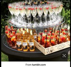 a table topped with lots of wine glasses and bottles filled with different types of drinks