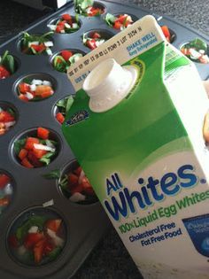 a carton of white's liquid sitting next to muffin tins filled with food