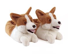 two brown and white stuffed dogs laying next to each other