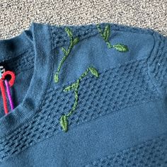 This is a thrifted size small crewneck sweater from GBG. It is blue with green leafy embroidery. Embroidered Blue Sweater For Fall, Fall Floral Embroidered Crew Neck Sweater, Blue Embroidered Sweater For Fall, Fitted Crew Neck Sweater With Floral Embroidery, Fitted Embroidered Crew Neck Sweater, Crew Neck Sweater With Custom Embroidery For Spring, Leafy Embroidery, Blue Hand, Crewneck Sweater