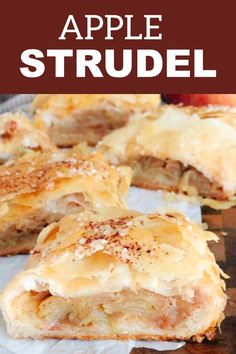 an apple strudel is cut in half and sitting on top of parchment paper