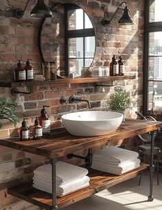 a bathroom with brick walls and a round mirror above the sink, surrounded by white towels