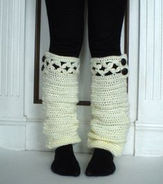 the legs and ankles of a woman wearing crocheted leg warmers with buttons