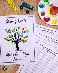 a tree with leaves on it next to some writing paper and paintbrushes that read strong roots make beautiful leaves