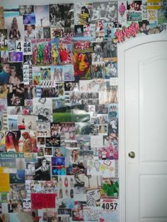 a wall covered in pictures and magnets next to a door