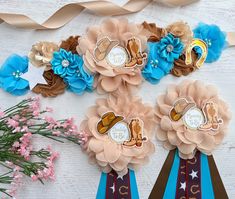 two ribbons with cowboy boots and flowers on them