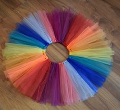 there is a circle made out of multicolored tulle on top of the floor