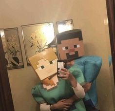 a man and woman dressed up as minecraft characters taking a selfie in the mirror