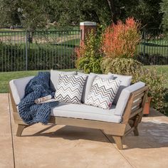 a couch sitting on top of a cement patio