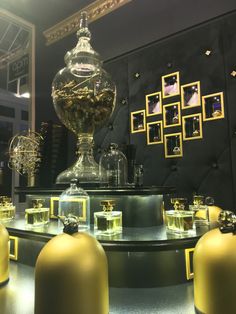 there are many glass vases on display in the room with gold trimmings