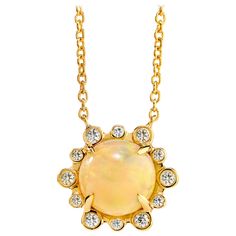 18 inch Opal Necklace created in 18 karat yellow gold Opal 1.5 carats approx. Diamonds 0.12 carat approx. Limited edition This 18-inch allurement is rendered with an opal of approximately 1.5 carats, set in 18 karat yellow gold and beckoned by 0.12 carats of gleaming diamonds. About the Designers ~ Dharmesh & Namrata Drawing inspiration from little things, Dharmesh & Namrata Kothari have created an extraordinary and refreshing collection of luxurious jewels. True believers of destiny, they alway Yellow Gold Ethiopian Opal Round Necklace, Luxury Yellow Gold Opal Necklace, Yellow Gold Ethiopian Opal Necklace, Elegant Ethiopian Opal Necklace In Yellow Gold, Gold Opal Necklace, Art Deco Pendant Necklace, Necklace With Diamonds, White Gold Pendant Necklace, Contemporary Necklace