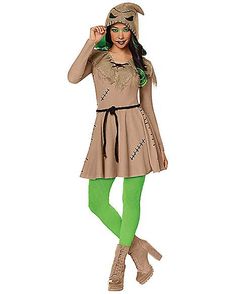 a woman dressed in a costume with green tights and boots is posing for the camera