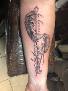 an elephant and lion tattoo on the left leg, with words written in cursive writing