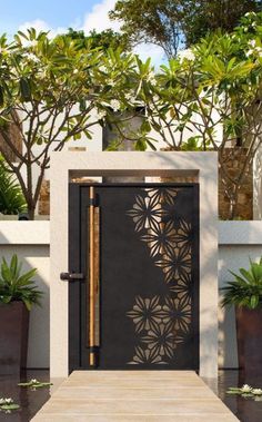 an entrance to a house with potted plants and trees in the backround