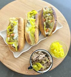 two hot dogs on buns with pickles and mustard