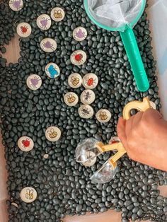 a person is holding a magnifying glass in front of some rocks and buttons