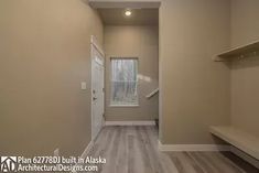 an empty walk in closet next to a window