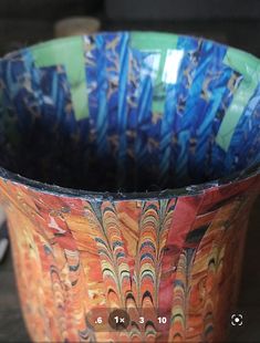 a colorful bowl sitting on top of a wooden table