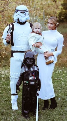 two women and a baby are dressed up as stormtroopers