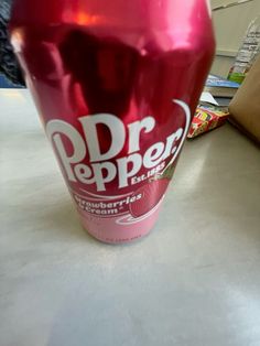 a red soda cup sitting on top of a table