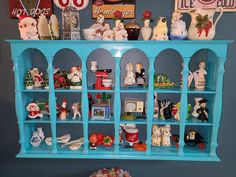 a blue shelf filled with lots of figurines