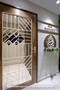 Apartment Designed with Cutwork Art That Adds Richness To Space | Studio Dream Creative - The Architects Diary Apartment Gate Design Entrance, Outer Door Design, Safety Gate For Main Door, Grill Door Design Front Entry Indian, Main Door Decoration Ideas Indian, Nameplates Design Ideas For Home Indian, Safety Door Design Entrance Wooden