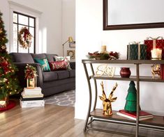 a living room decorated for christmas with a tree in the corner and presents under it