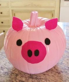 a pink pig pumpkin sitting on top of a counter