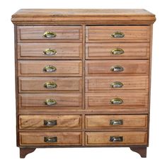 a wooden dresser with many drawers and knobs on it's sides, against a white background