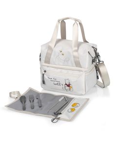 a white lunch bag with winnie the pooh design and utensils in it