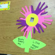 a flower made out of paper with the words happy mothers's day written on it