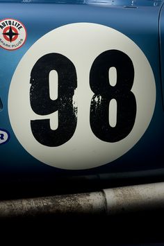 an old blue and white car with the number 98 on it's front bumper