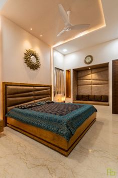 a large bed sitting in the middle of a bedroom next to a wall mounted fan