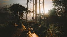 two people standing in the sun behind a tall water tower with barbed wire on top