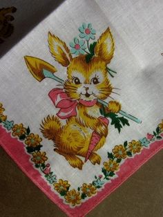 an embroidered napkin with a rabbit on it