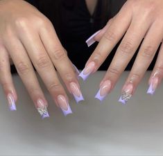 By @naturalnail_spa Extravagant Purple Nails, Purple French Tip Nails With Charms, Purple French Tips With Butterflies, Pastel Purple Acrylic Nails Lavender, Purple French Tip With Gems, Light Purple Nails With Gems, Purple Acrylic Nails With Charms, Lavender French Tip Acrylic Nails, Purple Nail Designs With Charms