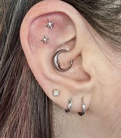 a woman with three piercings on her ear