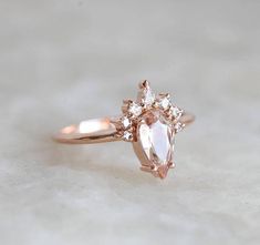 Beautiful handmade peach sapphire ring with sparkly diamond crown. Feminine and unique. ORIGINAL DESIGN FROM MINIMALVS Product details Gemstone: peach sapphire 1.25 - 1.3 carat, color of sapphire may vary a bit from champagne peach to pink peach due to natural characteristics of sapphire Blush Diamond Wedding Jewelry, Blush Diamond Jewelry For Wedding, Elegant Peach Gemstone Ring, Rose Gold Diamond Cluster Ring With Gemstones, Blush Diamond Jewelry With Prong Setting, Elegant Peach Ring For Anniversary, Elegant Peach Ring Jewelry, Elegant Peach Ring, Elegant Peach Colored Ring Jewelry