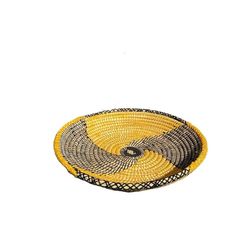 a yellow and black basket sitting on top of a white wall